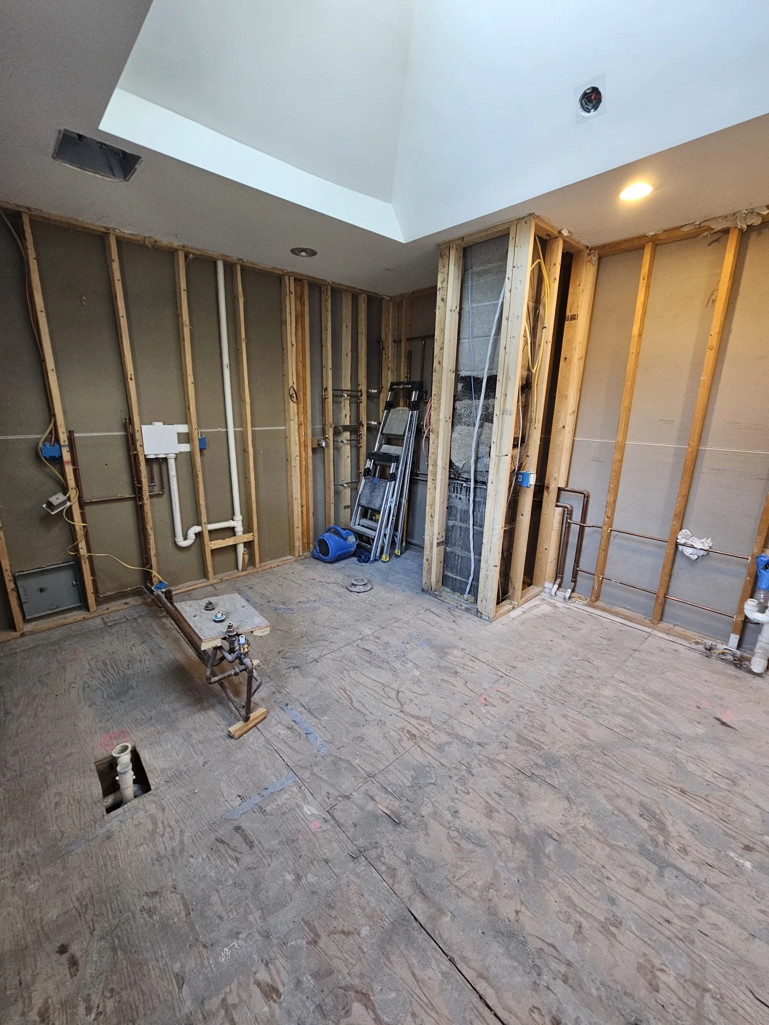 Basement remodeling in progress with framed walls, drywall, and electrical rough-in work — Basement Remodeling by Innovative Build Solutions.