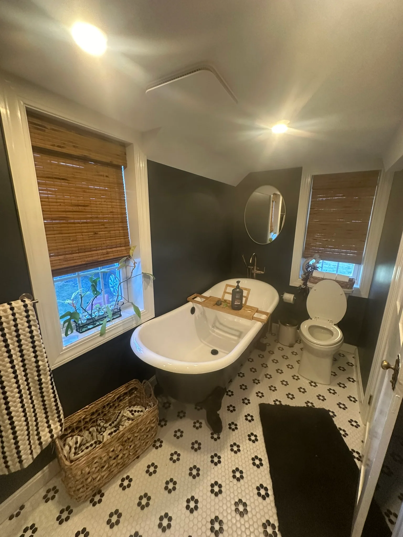 Modern bathroom with freestanding soaking tub, pedestal sink, and patterned hexagonal tile floor — Countertop Installation by Innovative Build Solutions.
